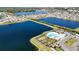 Aerial view of community pool and clubhouse surrounded by palm trees and residential homes at 1236 7Th Nw Ave, Ruskin, FL 33570