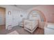 Charming Bedroom with a crib, rainbow decor, and cozy armchair at 1236 7Th Nw Ave, Ruskin, FL 33570