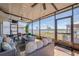 Relaxing screened patio featuring a ceiling fan, comfortable seating, and scenic views of the backyard at 1236 7Th Nw Ave, Ruskin, FL 33570