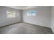 Bright bedroom featuring gray walls, two windows and laminate floors at 207 Dolphin N Dr, Oldsmar, FL 34677