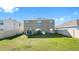 Spacious backyard featuring a well-maintained lawn, patio area, and privacy fence at 7522 Rosewood Garden Loop, Tampa, FL 33637