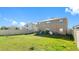Expansive backyard featuring a well-maintained lawn, patio area, and privacy fence at 7522 Rosewood Garden Loop, Tampa, FL 33637