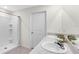 Bright bathroom featuring a double sink vanity with granite countertops and a walk-in shower at 7522 Rosewood Garden Loop, Tampa, FL 33637
