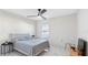 Bright bedroom with white walls, ceiling fan, window, bed, and tile flooring at 7522 Rosewood Garden Loop, Tampa, FL 33637