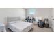 Well-lit bedroom with carpeted floors, a window, and minimalistic furniture at 7522 Rosewood Garden Loop, Tampa, FL 33637