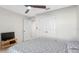 This bright bedroom has a ceiling fan, white walls, and large closet with double doors at 7522 Rosewood Garden Loop, Tampa, FL 33637