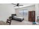 Cozy bedroom with a neutral color palette, carpeted floor, and a modern ceiling fan at 7522 Rosewood Garden Loop, Tampa, FL 33637