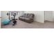 Bonus room with a reclining couch and exercise equipment at 7522 Rosewood Garden Loop, Tampa, FL 33637