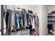 Walk-in closet with ample storage, featuring rods, shelves, and gray storage drawers at 7522 Rosewood Garden Loop, Tampa, FL 33637