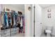 Well-organized walk-in closet featuring ample hanging space and storage drawers, located near the bathroom at 7522 Rosewood Garden Loop, Tampa, FL 33637