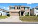 Charming two-story home with a well-maintained lawn, two car garage, and appealing curb appeal at 7522 Rosewood Garden Loop, Tampa, FL 33637