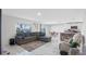 Cozy living room showcasing tile floors, a comfortable sectional, a view of the kitchen, and an adjacent dining area at 7522 Rosewood Garden Loop, Tampa, FL 33637