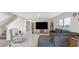 Spacious living room showcasing tile floors, comfortable seating, a large entertainment center, and access to an adjacent bathroom at 7522 Rosewood Garden Loop, Tampa, FL 33637