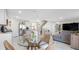 Bright, open-concept living and dining area featuring modern furnishings and tile flooring at 7522 Rosewood Garden Loop, Tampa, FL 33637