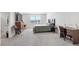 Spacious carpeted main bedroom featuring a bed, desk, dresser, and chairs at 7522 Rosewood Garden Loop, Tampa, FL 33637