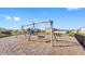 Community playground featuring swings and play structures within a fenced area at 7522 Rosewood Garden Loop, Tampa, FL 33637