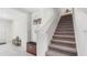 Inviting foyer with tile flooring leading to a carpeted staircase and upper level at 7522 Rosewood Garden Loop, Tampa, FL 33637