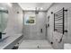 Modern bathroom featuring a walk-in shower with glass enclosure, sleek gray tiles, and a floating sink at 115 N Blvd Of The Presidents, Sarasota, FL 34236