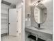 Stylish bathroom featuring a unique mirror, modern vanity with a sink and an open door to closet at 115 N Blvd Of The Presidents, Sarasota, FL 34236