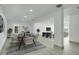 Spacious dining room with modern table, chairs, light wood floor and access to multiple other living spaces at 115 N Blvd Of The Presidents, Sarasota, FL 34236