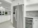 Modern kitchen with stainless steel appliances, including refrigerator and wine cooler at 115 N Blvd Of The Presidents, Sarasota, FL 34236