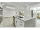 Modern kitchen with island, stainless steel appliances, and light-filled dining area at 115 N Blvd Of The Presidents, Sarasota, FL 34236