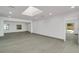 Open concept living room with light wood floor, skylight and access to the pool area at 115 N Blvd Of The Presidents, Sarasota, FL 34236