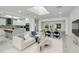 Bright and airy living room with skylight, open floor plan, and modern furnishings at 115 N Blvd Of The Presidents, Sarasota, FL 34236