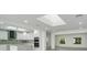 Open concept living space with a skylight, modern kitchen, and bright dining area at 115 N Blvd Of The Presidents, Sarasota, FL 34236
