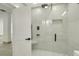 Bright shower space with a glass door, rain shower head, and sleek bench at 115 N Blvd Of The Presidents, Sarasota, FL 34236