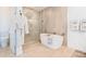 Bright bathroom featuring a soaking tub, glass shower and stylish fixtures at 15 Avalon St St # 803, Clearwater Beach, FL 33767