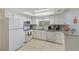 Well-lit kitchen with stainless steel appliances and light, bright cabinets at 1602 W Dorchester Dr, Palm Harbor, FL 34684