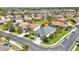 Aerial view of the lovely home nestled in a vibrant neighborhood with lush landscaping and mature trees at 2640 Suncoast Lakes Blvd, Punta Gorda, FL 33980