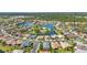 An aerial view of a residential community surrounding a lake with lush landscaping and beautiful homes at 2640 Suncoast Lakes Blvd, Punta Gorda, FL 33980