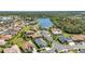 An aerial view of single Gathering homes surrounding a lake and lush green space at 2640 Suncoast Lakes Blvd, Punta Gorda, FL 33980