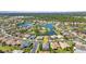 Aerial view of a home within a lushly landscaped community surrounding a lake at 2640 Suncoast Lakes Blvd, Punta Gorda, FL 33980