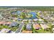 An aerial capture of charming single-Gathering homes near a lake, surrounded by lush greenery at 2640 Suncoast Lakes Blvd, Punta Gorda, FL 33980