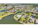 This aerial shot highlights lakeside community homes with a beautiful pool, perfect for relaxing at 2640 Suncoast Lakes Blvd, Punta Gorda, FL 33980