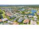 An aerial image showcasing single-Gathering homes situated around a beautiful lake and mature trees at 2640 Suncoast Lakes Blvd, Punta Gorda, FL 33980