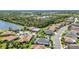 An aerial view of single Gathering homes nestled around a serene lake and mature landscaping at 2640 Suncoast Lakes Blvd, Punta Gorda, FL 33980