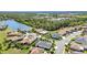 An aerial shot showcasing the neighborhood's homes surrounding a lake and mature landscaping at 2640 Suncoast Lakes Blvd, Punta Gorda, FL 33980