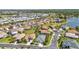 An aerial view of a charming neighborhood featuring well-maintained lawns and a serene lake at 2640 Suncoast Lakes Blvd, Punta Gorda, FL 33980