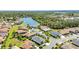 Aerial view of homes surrounding a lake and mature trees in a vibrant community at 2640 Suncoast Lakes Blvd, Punta Gorda, FL 33980