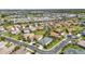 An aerial view of a charming neighborhood with single-Gathering homes, green lawns, and a golf course in the distance at 2640 Suncoast Lakes Blvd, Punta Gorda, FL 33980
