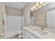 Bright bathroom featuring white cabinets, modern lighting, and a tub/shower combination at 2640 Suncoast Lakes Blvd, Punta Gorda, FL 33980