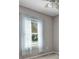 Bright bedroom featuring a large window with sheer curtains, neutral walls and plush carpeting at 2640 Suncoast Lakes Blvd, Punta Gorda, FL 33980
