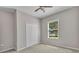 Cozy bedroom with neutral walls and carpet flooring featuring a window and ceiling fan at 2640 Suncoast Lakes Blvd, Punta Gorda, FL 33980