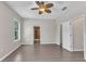 The main bedroom with a ceiling fan and tile floors at 2640 Suncoast Lakes Blvd, Punta Gorda, FL 33980