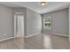 Simple bedroom featuring light gray walls, tile flooring, and a window offering natural light at 2640 Suncoast Lakes Blvd, Punta Gorda, FL 33980