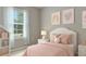 Cozy bedroom showcasing a white bed frame, pastel decor, and a bright window with natural light at 2640 Suncoast Lakes Blvd, Punta Gorda, FL 33980